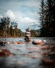 Selective focus shot of stones stacked on top of each other in the river © Aj Thakur/Wirestock Creators