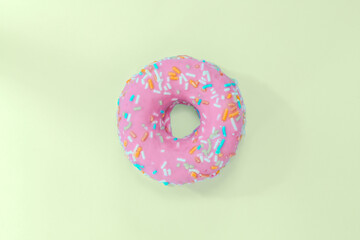 pink solitary donut with green background in pastel tones, which gives a modern air at the same time as retro. This to eat it