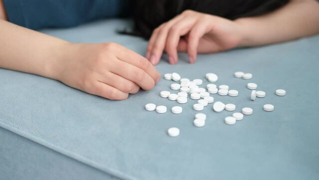 Overdose pills and addict concept background. woman sleep unconscious after eaten pills on bed,Commit suicide, Drug overdose concept