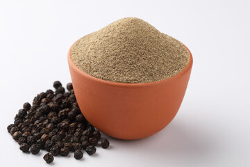 Indian spices - black pepper powder,Black pepper corns scattered on white background and Black pepper Powder on Glass bowl isolated on white background.