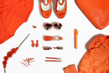 Fashionable items of women's clothing and accessories in orange on a white background.