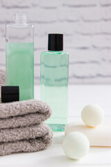 Obraz na płótnie Canvas Bath concept beauty products cotton towels vertical front view.