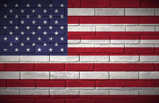 United States. Flag painted on a brick wall.  Stany Zjednoczone. Flaga namalowana na ceglanym murze.