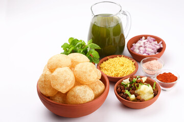 Panipuri or Golgappa is a popular street snack from India. It's a round, hollow puri filled with a mixture of flavoured water and other chat items - obrazy, fototapety, plakaty