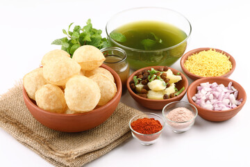 Panipuri or Golgappa is a popular street snack from India. It's a round, hollow puri filled with a mixture of flavoured water and other chat items - obrazy, fototapety, plakaty