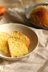 Plate of traditional sweet bread, eaten at Easter time in Croatia. Easter bunny, eggs and flowers on the table. Selective focus.