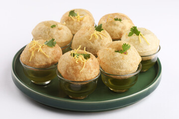 Panipuri or Golgappa is a popular street snack from India. It's a round, hollow puri filled with a mixture of flavoured water and other chat items © SMD IMAGES