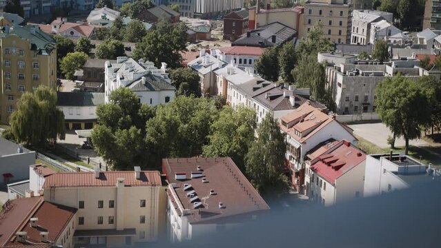 Cozy courtyards of Rakovsky suburb with green trees - low-rise old historical building in Minsk. Aerial view of eco-friendly microdistrict of city. New houses are being built.