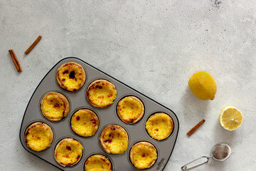 Pastel de nata or pastel de Belem - traditional portuguese dessert in the gray baking mold. Top view. 