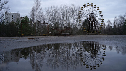 Pripyat abandoned ferris wheel in amusement park with radioactive contamination after nuclear...