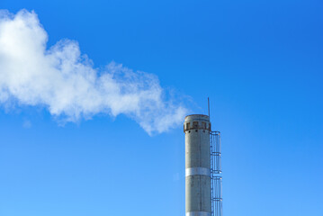 white smoke from boiler pipe against background of blue sky, boiler room, boiler plant