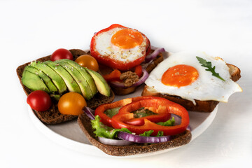 Sandwiches or toasts on the white plate. Delicious family breakfast in the morning.