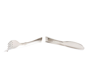 Knife and fork stacked up isolated on white background. Side View.	