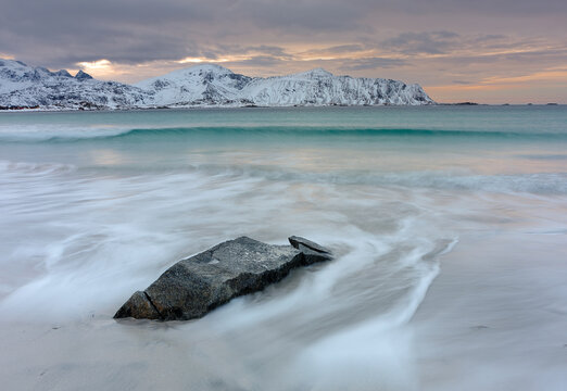 Nordic beach with srone and mountains background