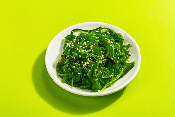 Chuka Seaweed Salad with sesame seeds and nut sauce. Trendy hard light, dark shadow