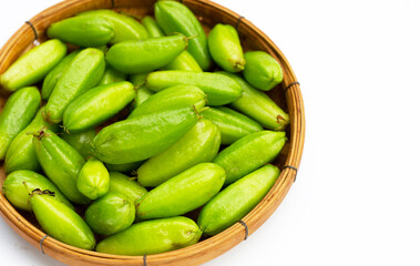 Bilimbi fruit in bamboo basket on white background.