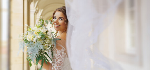 Beautiful young bride with bouquet of flowers on color background