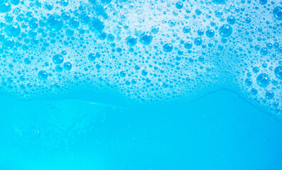 Detergent foam bubble on blue background.