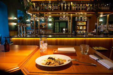 Interior of modern loft style restaurant. Bar counter. Interior porch with fresh flowers