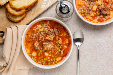 Beef barley soup with vegetables, potato, green peas, carrot, celery, onion and tomato. Bread....