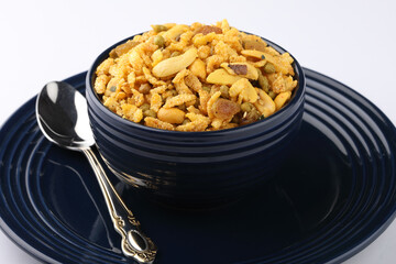 Indian Namkeen Snacks served in ceramic bowl & plate OR Indian traditional Namkeen Food Navratan Mixture or Navratna Mix Namkeen Also Know as Nimco, Namkin, Mixture or Nimko