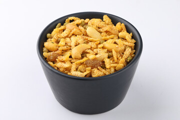 Indian Namkeen Snacks served in ceramic bowl & plate OR Indian traditional Namkeen Food Navratan Mixture or Navratna Mix Namkeen Also Know as Nimco, Namkin, Mixture or Nimko