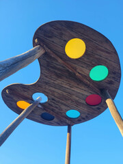 Wooden roof panel with colorful windows on a playground equipment