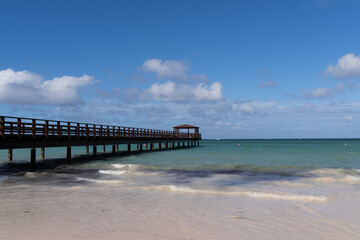 Side shot of wooden pier walk at Impressive Hotel Punta Cana on wooden pier at day time. - obrazy, fototapety, plakaty