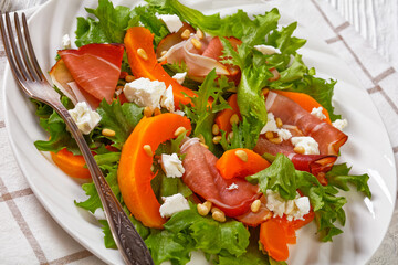 pumpkin salad with lettuce, crumbled cheese, ham