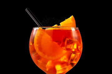 Glass of aperol spritz cocktail on black background. Close up