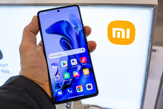 Smartphone Xiaomi in hand. Customer choosing smartphone in mobile phones store. Minsk, Belarus - February, 2022