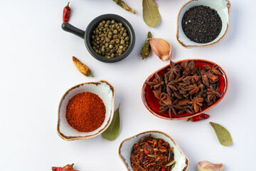 Bowls with various spices on white background