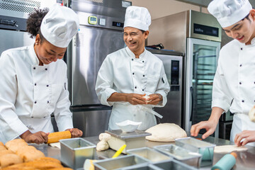Smiling  african american young female bakers looking at camera..Chefs  baker in a chef dress and...