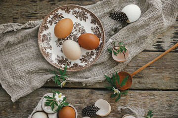 Easter rustic still life. Natural easter eggs, blooming spring flowers, burlap and spoon  flat lay...