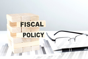 FISCAL POLICY is written on wooden blocks on a chart background