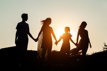 Fototapeta na wymiar happy family parents holding hands. mom with daughter and son are dream happy in park. family friendly kid dream concept, sunlight