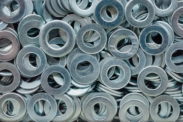 Flat washers under the nut, pattern. Background of round fasteners for the bolt