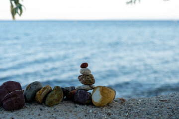 Fototapeta na wymiar a relaxing zen concept photo of small stones put next to eachother as organised on the beach,