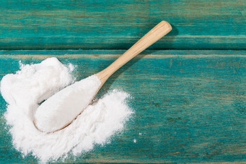 Spoon Of With Baking Soda; Photo On Wood Background