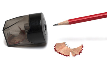 Closeup red pencil sharpener scraped white background - Powered by Adobe
