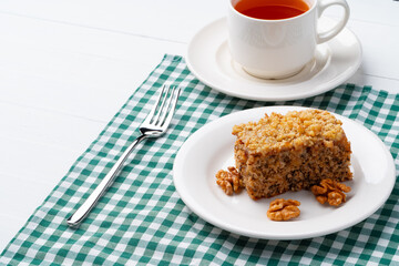 Piece of nut cake on white plate