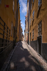 Narrow street view in the old town Gamla Stan a sunny spring day in Stockholm
