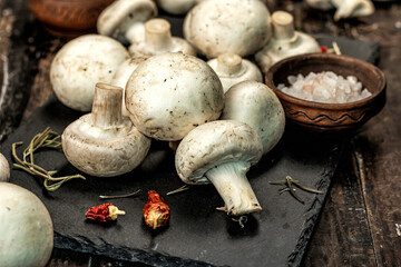 Fresh champignons with spices and herbs. Raw ingredient for cooking vegan food