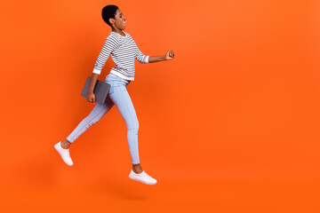 Fototapeta na wymiar Full length body size view of attractive cheerful girl jumping going copy space isolated over shine orange color background