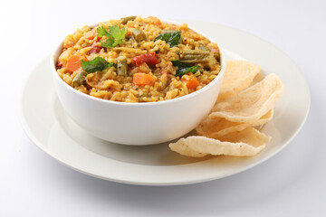 Sambar Rice - Tasty and popular south indian recipe served in a ceramic bowl with appalam or papad