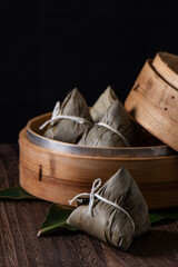 Fototapeta na wymiar Zongzi. Rice dumpling for Dragon Boat Festival on dark wooden table background.