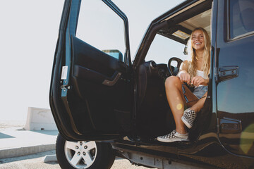 Fototapeta na wymiar surfer girl sitting at a car in Malibu. On film California