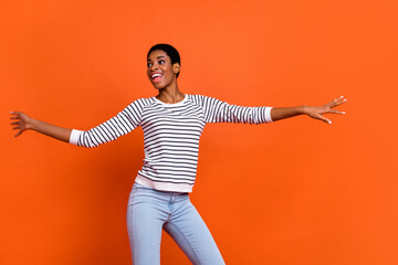 Photo of pretty charming butch lady dressed sweater dancing smiling isolated orange color background