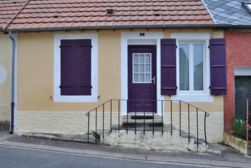 Stepped Entrance to Old House with Purple Painted Shutters and Door