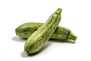 Fresh cut zucchini isolated on a white background with clipping path. Design element for product label. Design image of fresh whole zucchini. Green zucchini vegetables isolated on white.
